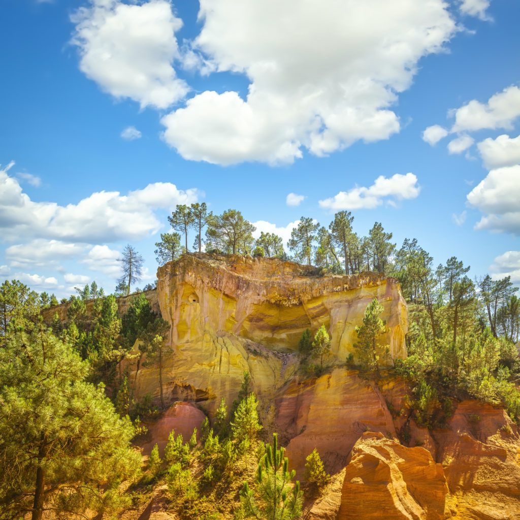 Les Ocres du Roussillon, red rocks and trees. Provence, France