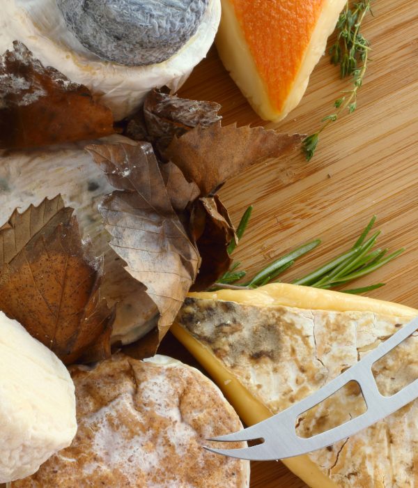French Cheese composition on wooden board close-up